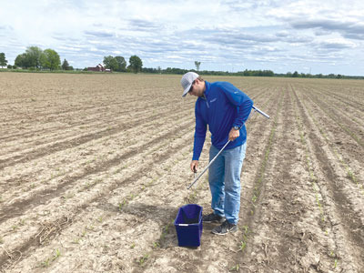 Cole Cameron taking soil samples