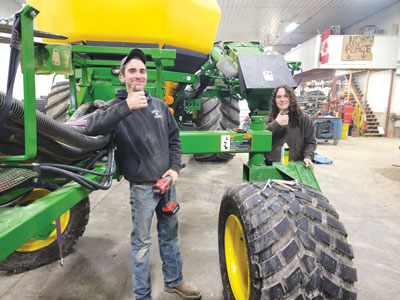 co-op students working on tractor