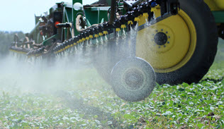 Traditional Farm Equipment spraying field