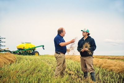 Cargill advising young farmer in Saskatchewan field