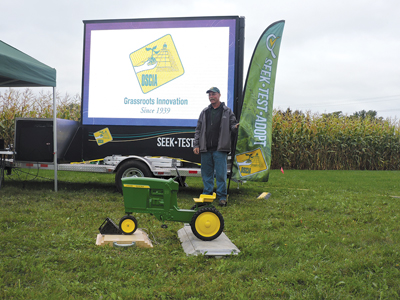 Chad Anderson standing next to Soil Health Trailer