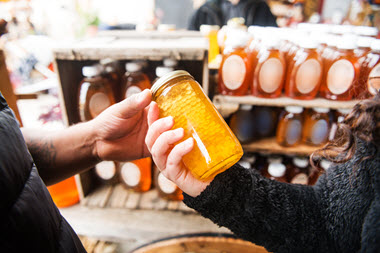 Consumers holding honey
