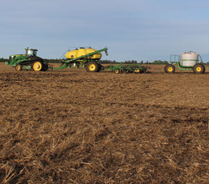 John Deere fertilizer equipment in field