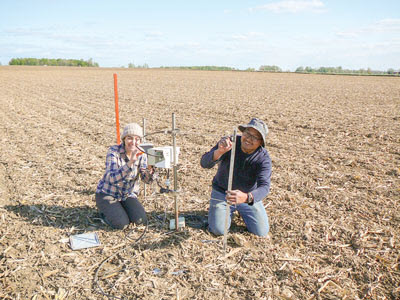 farmers setting up air sample intakes in field
