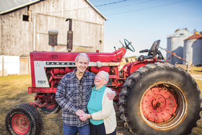 John Stafford and wife Betty, and their Farmall 806.