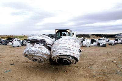 Tractor bales wrapped in plastic