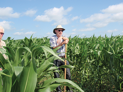 Patrick standing in corn field