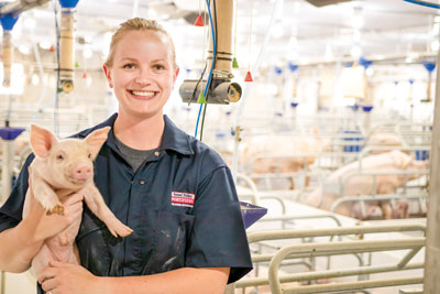Victoria Seip Eisses holding a piglet
