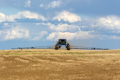 tractor spraying field