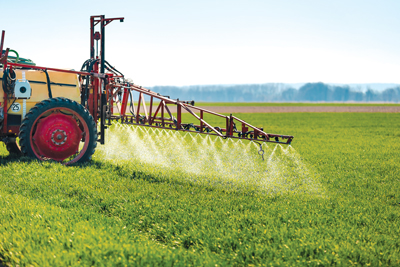 Field being sprayed with herbicides
