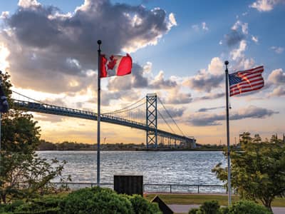 Canada flag & United States Flag near bridge